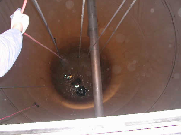 The figure shows a view down the single PVC geomembrane lined concrete silo which is 21 ft in diameter lined to a height of 65 ft. 